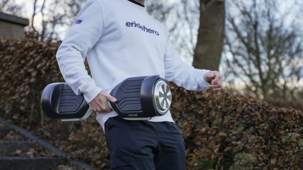 Rasmus Barslund from ERideHero carrying a hoverboard to show off its portability