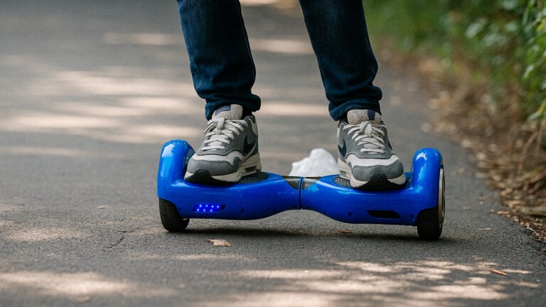 Man riding a blue hoverboard on an asphalt road