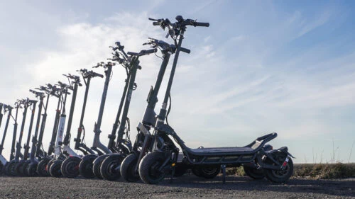 A full lineup with some of the fastest electric scooters in the world with a a blue sky in the background
