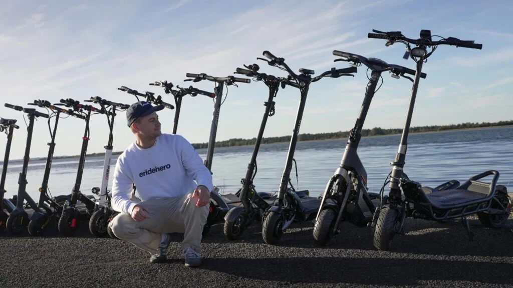 Rasmus from ERideHero with a range of heavy duty electric scooters behind
