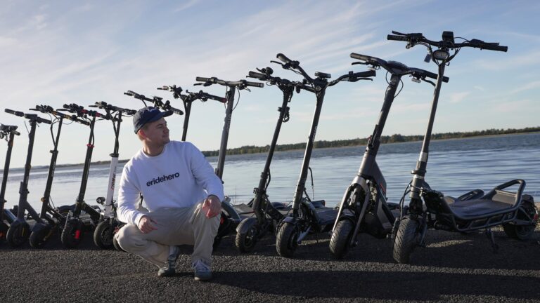 Rasmus from ERideHero with a range of heavy duty electric scooters behind