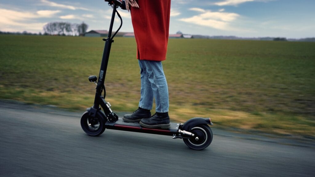 Girl riding on the evolv tour xl-r electric scooter