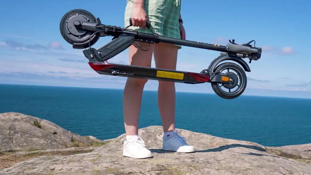 girl holding an E-twow booster gt se in a carrying strap