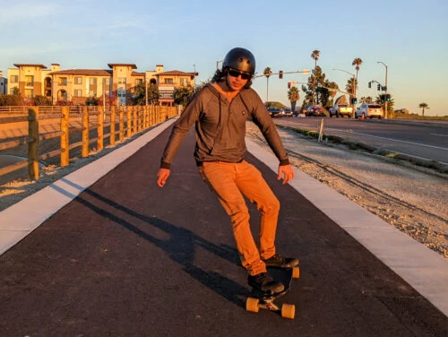 Electric longboarder carving on the bike lane