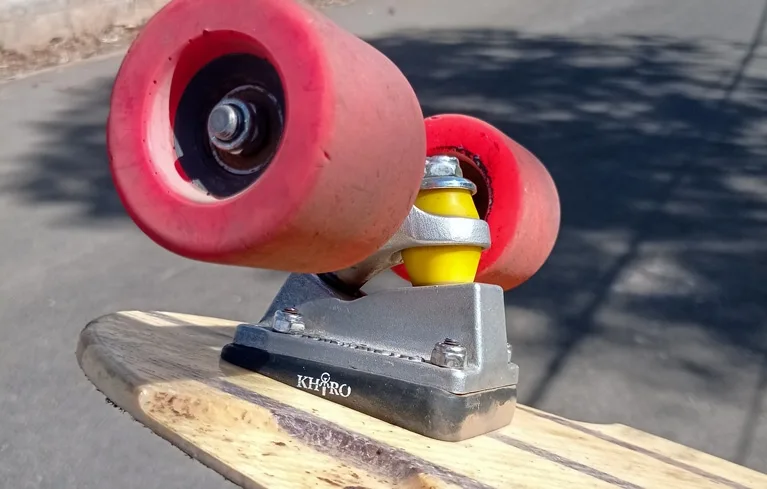 Wedge riser being used on a longboard