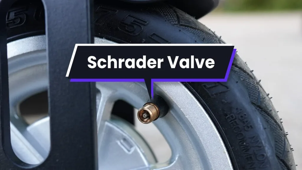 Close-up of a Schrader valve on an electric scooter tire
