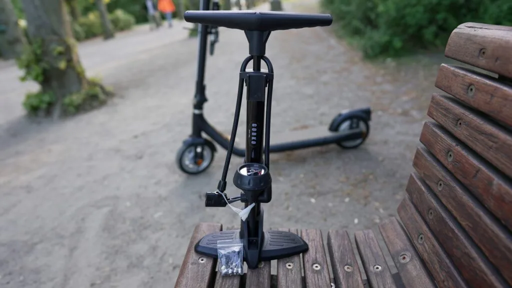 Close-up of the GOBKO floor pump with an electric scooter in the background