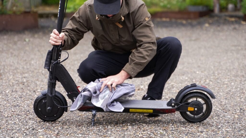 Wiping down an electric scooter after riding in the rain