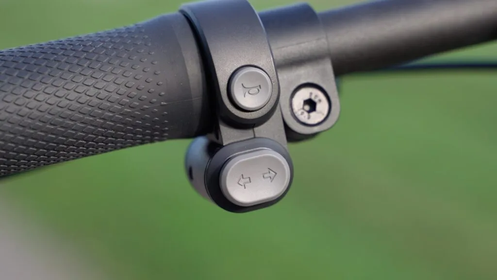 Closeup of turn signal buttons and horn button on the Segway Ninebot KickScooter Max G2