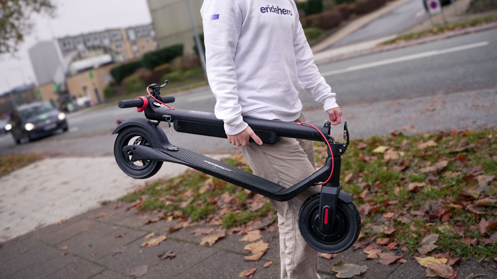https://eridehero.com/wp-content/uploads/2023/11/Rasmus-from-ERideHero-carrying-a-folded-electric-scooter-with-one-hand-1.jpg?utm_source=chatgpt.com