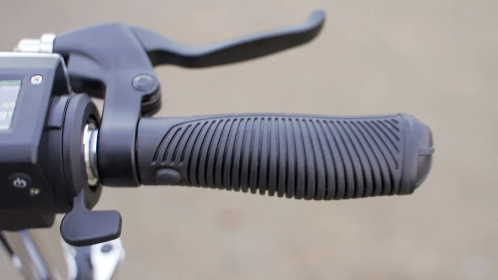 Close-up of the right handlebar grip and throttle on the FluidFreeRide Mosquito with a blurred background
