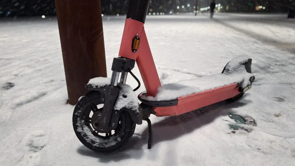 Closeup of an electric scooter's tire in the snow