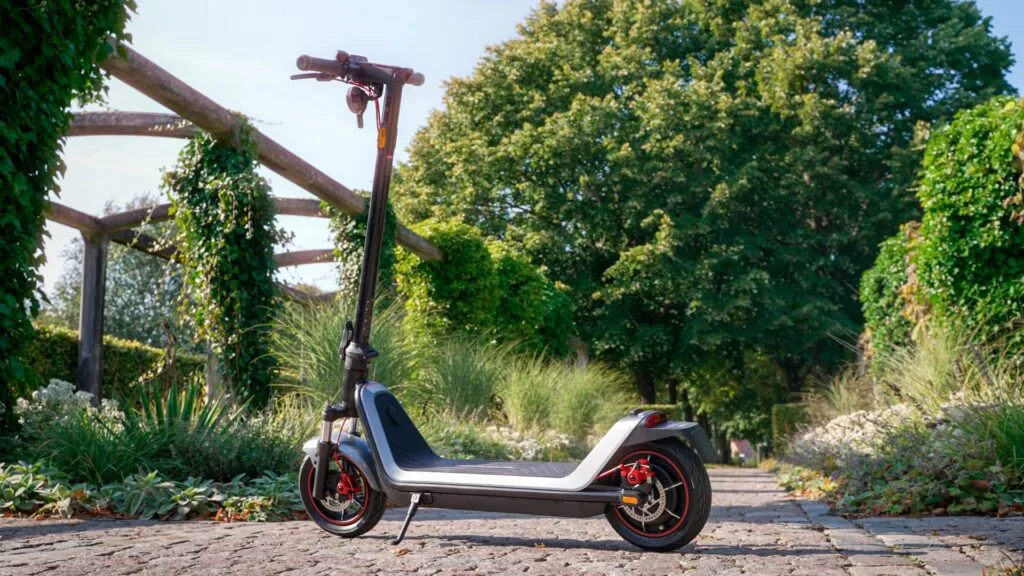 NIU KQi 300X on cobblestone path with green background