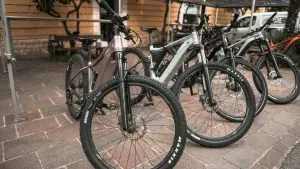 A row of electric bikes on a sidewalk