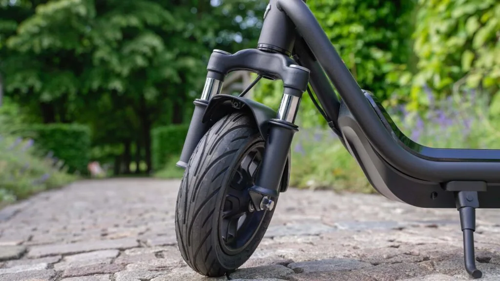 Closeup of the front tire and fork suspension on NIU KQi 100F