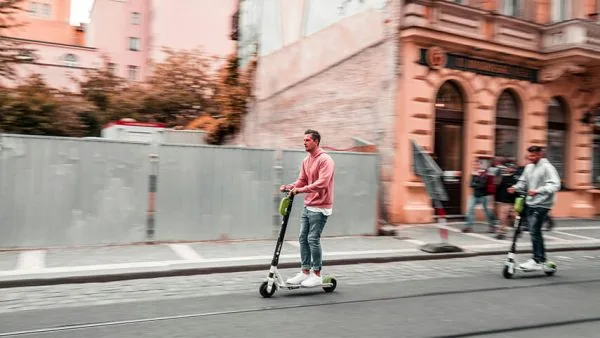 Man riding electric scooter without helmet