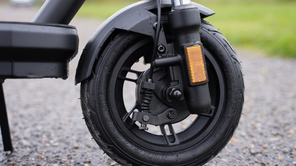 Close-up of the VMAX VX2 Lite front drum brake, hydraulic fork and 10-inch tubeless tire